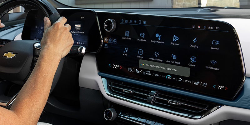 Driver's view of the steering wheel and infotainment touchscreen in a 2027 Chevrolet Equinox.